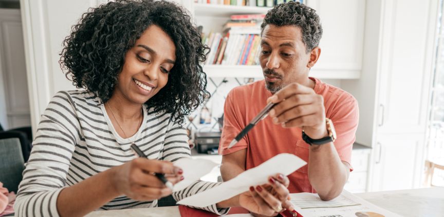 A man and woman looking over tax paperwork.