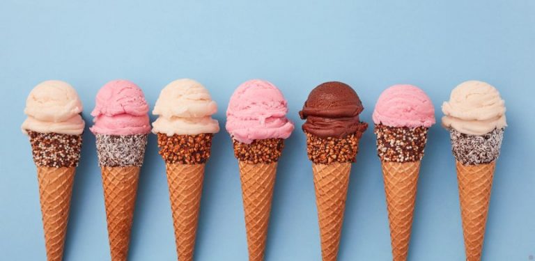 Ice cream cones in a line on a blue background.