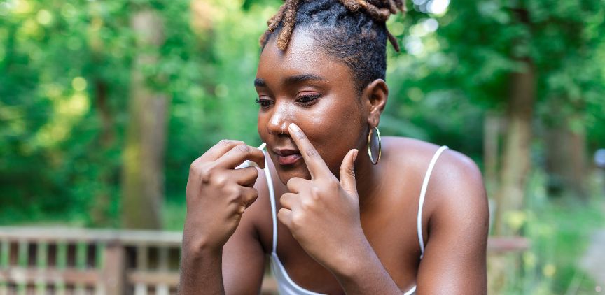 A woman using nasal spray.