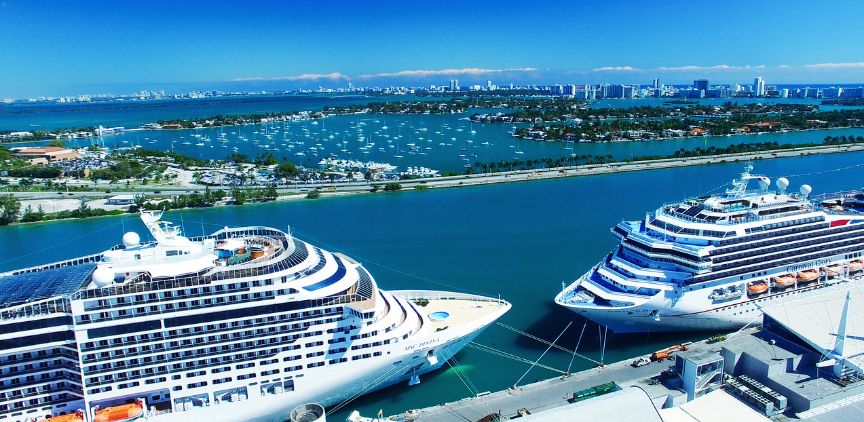 Two cruise ships facing each other, docked at port.