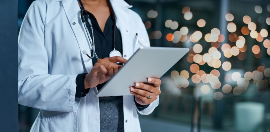 A female doctor looking at a clipboard.